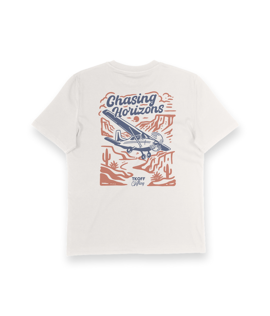 White t-shirt with 'Chasing Horizons' graphic design featuring an airplane and desert landscape on a white background.